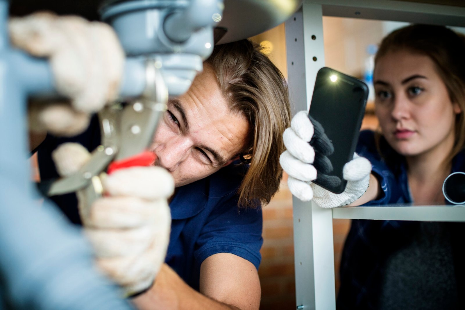 Couple fixing kitchen sink